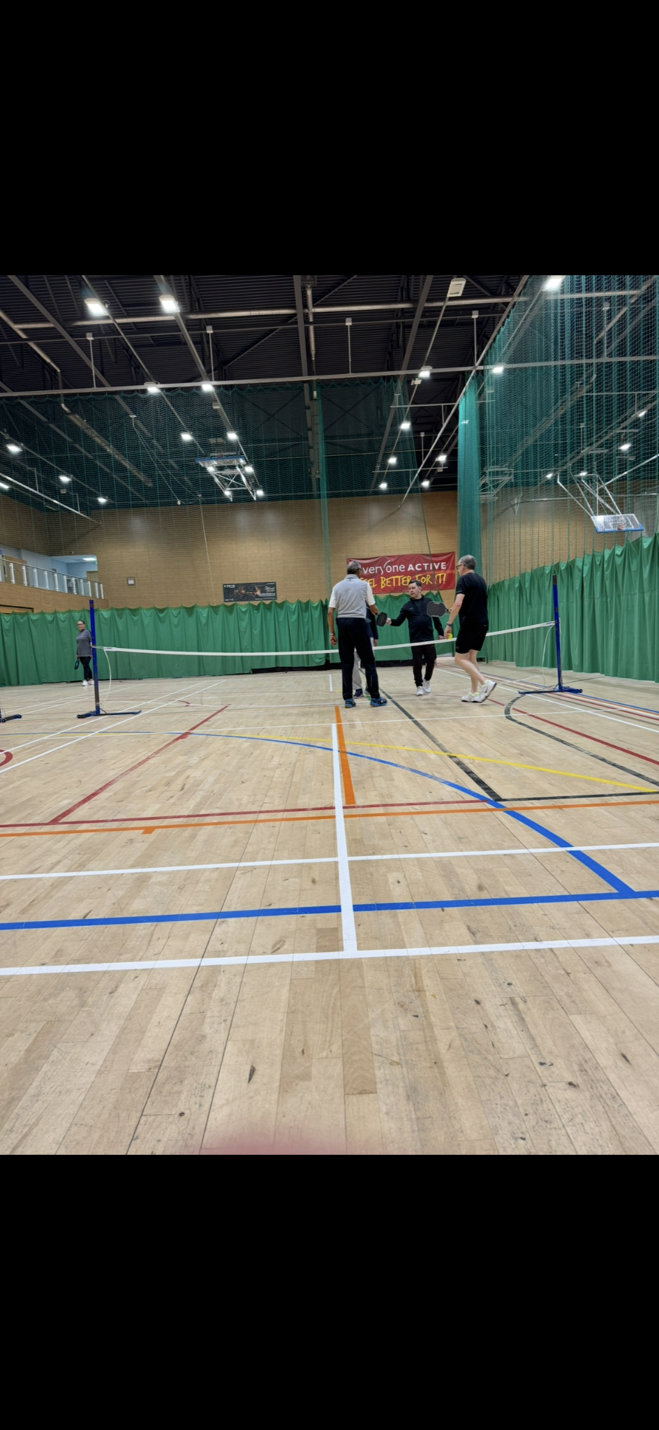 Players meeting at the pickleball net at Watford Woodside