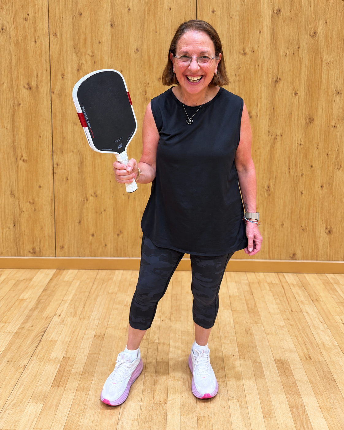 Jane holding her Boomstik-style pickleball paddle